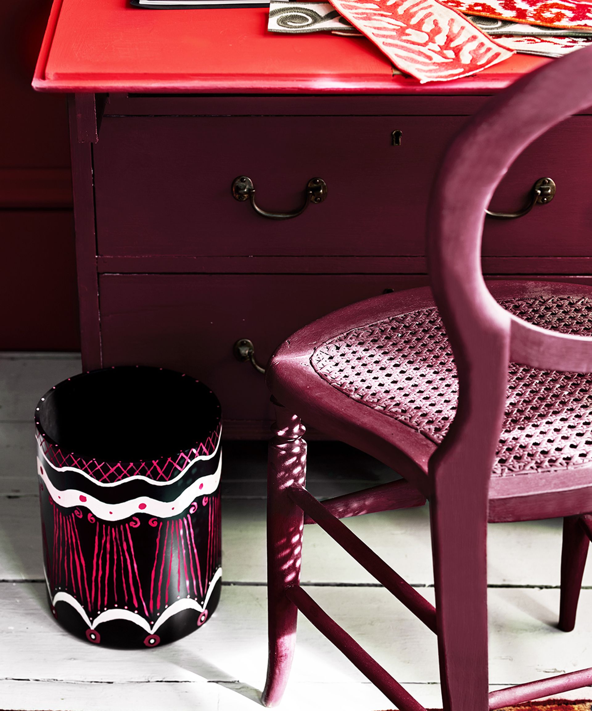 A home office with chair, desk and waste bin decorated with Annie Sloan Chalk Paint in shades Emperor's Silk Burgundy, Old White, and Capri Pink
