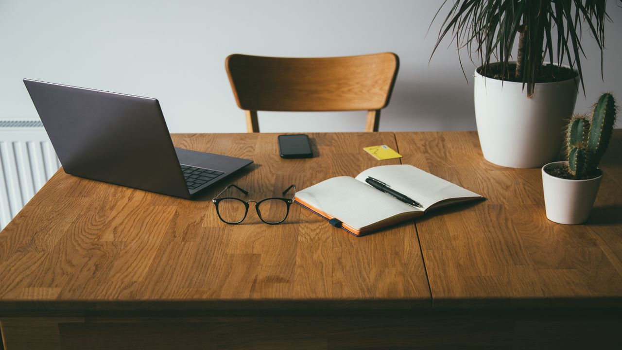 Desk with open book and laptop