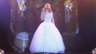 Hilary Duff shows up to dance in a mask and an old wedding dress in pretty Cinderella story moment.