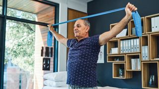 Man doing strength training exercises with a resistance band