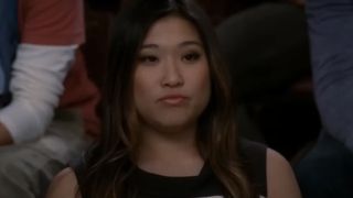 Jenna Ushkowitz sitting during glee club on Glee