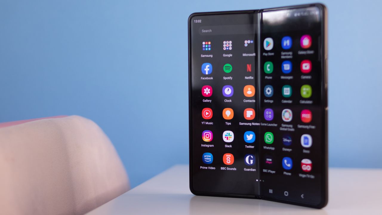 A photograph of the Samsung Galaxy Z Fold 3 unfolded and stood on a table