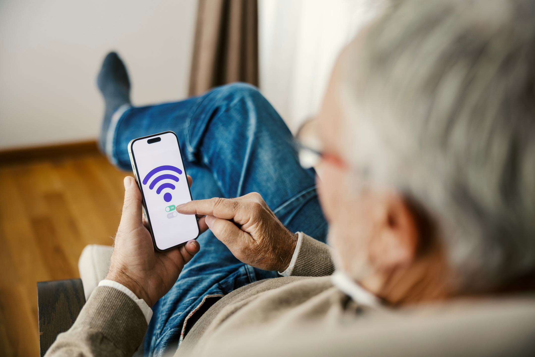 A man connecting his phone to his home internet.