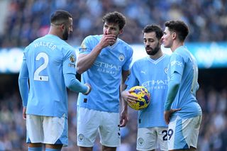 Kyle Walker, Ruben Dias, Bernardo Silva and Julian Alvarez of Manchester City interact during the Premier League match between Manchester City and Liverpool FC at Etihad Stadium on November 25, 2023 in Manchester, England. (Photo by Michael Regan/Getty Images)