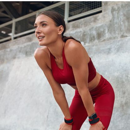 A woman working out outside utilising the many wrist weight benefits