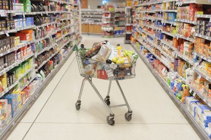 grocery cart in grocery store aisle for food tax story