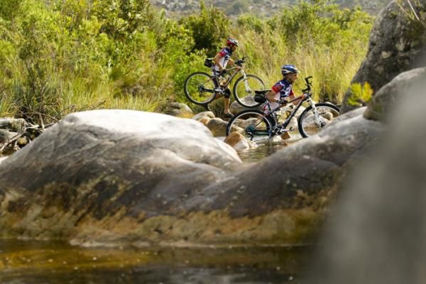 Riders cross the sandspruit