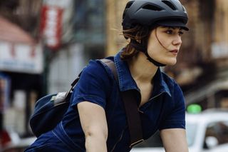 Woman riding in traffic with a giro helmet