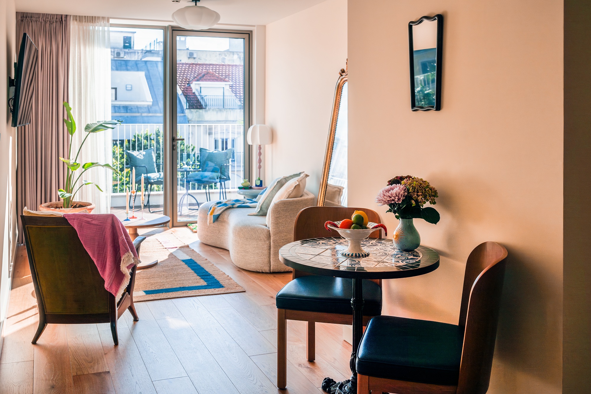 a living space in an anthropologie hotel suit with a small bistro table in the foreground