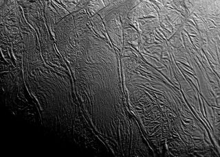 orbital view of Enceladus showing ripples and cracks in the icy surface