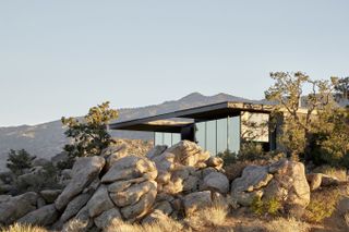 High Desert Retreat by Aidlin Darling Design peeking out of the rocky terrain