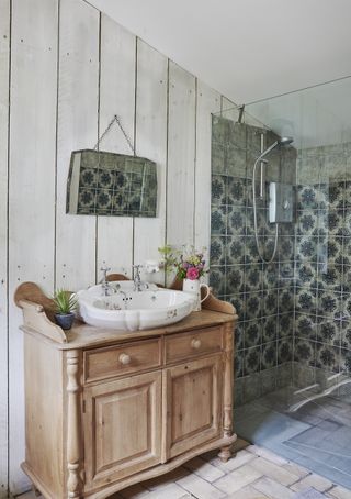 rustic weatherboard paneling in bathroom iwht vintage sink and reclaimed dresser