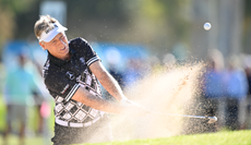 Bernhard Langer strikes a bunker shot