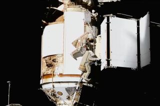 Russian cosmonauts Sergey Prokopyev and Dmitry Petelin work to deploy a radiator for the Nauka multipurpose laboratory module during a spacewalk at the International Space Station on Friday, May 12, 2023.