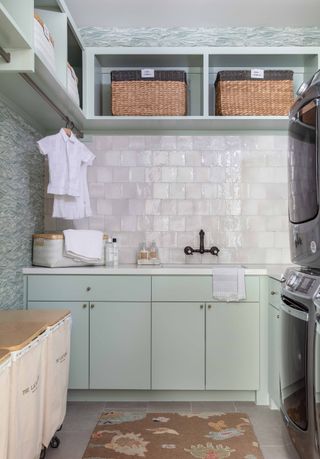 A laundry room with fabric boxes