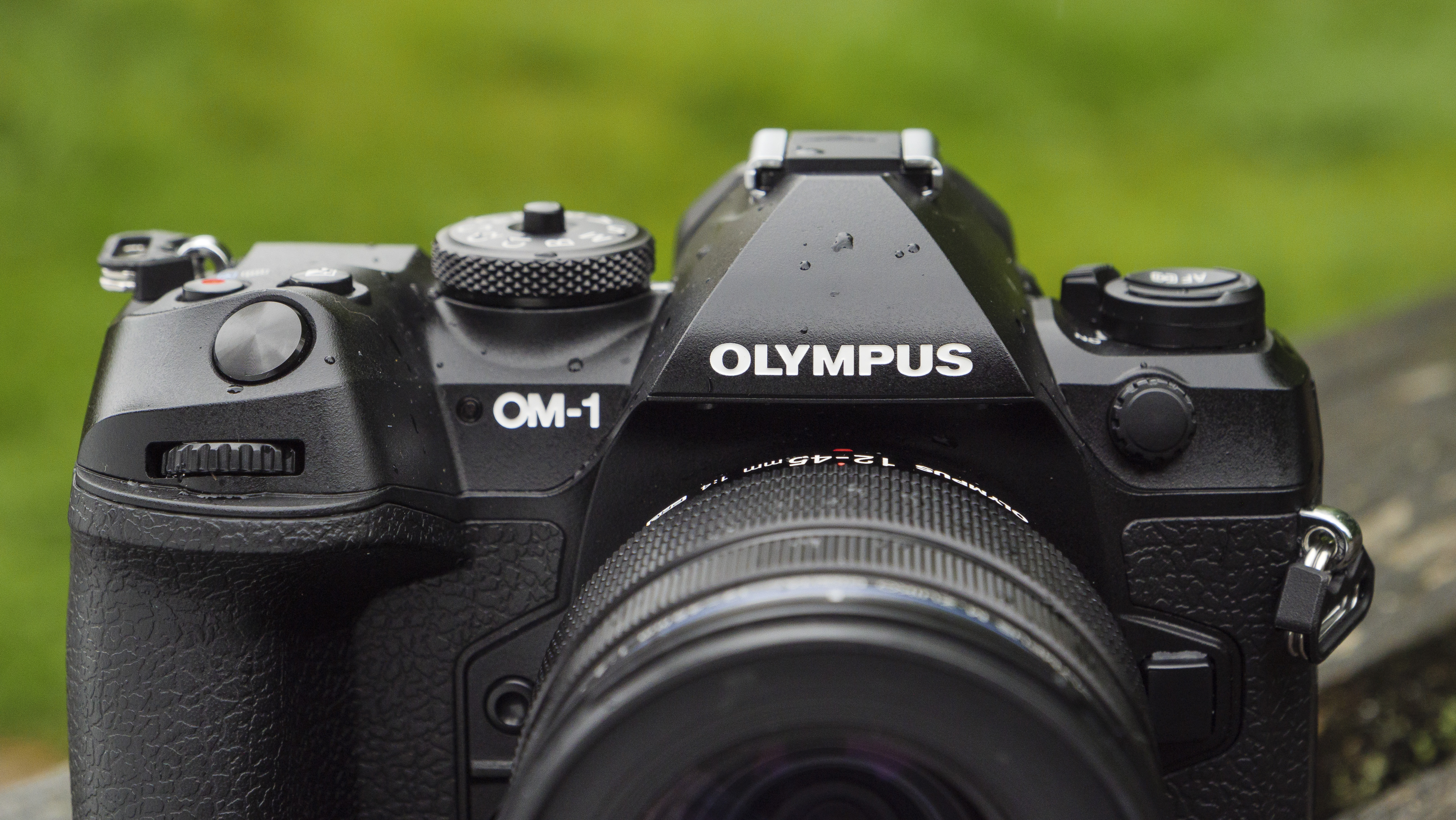 The OM System OM-1 camera on a wooden table