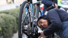 Mechanic looks over a WorldTour bike