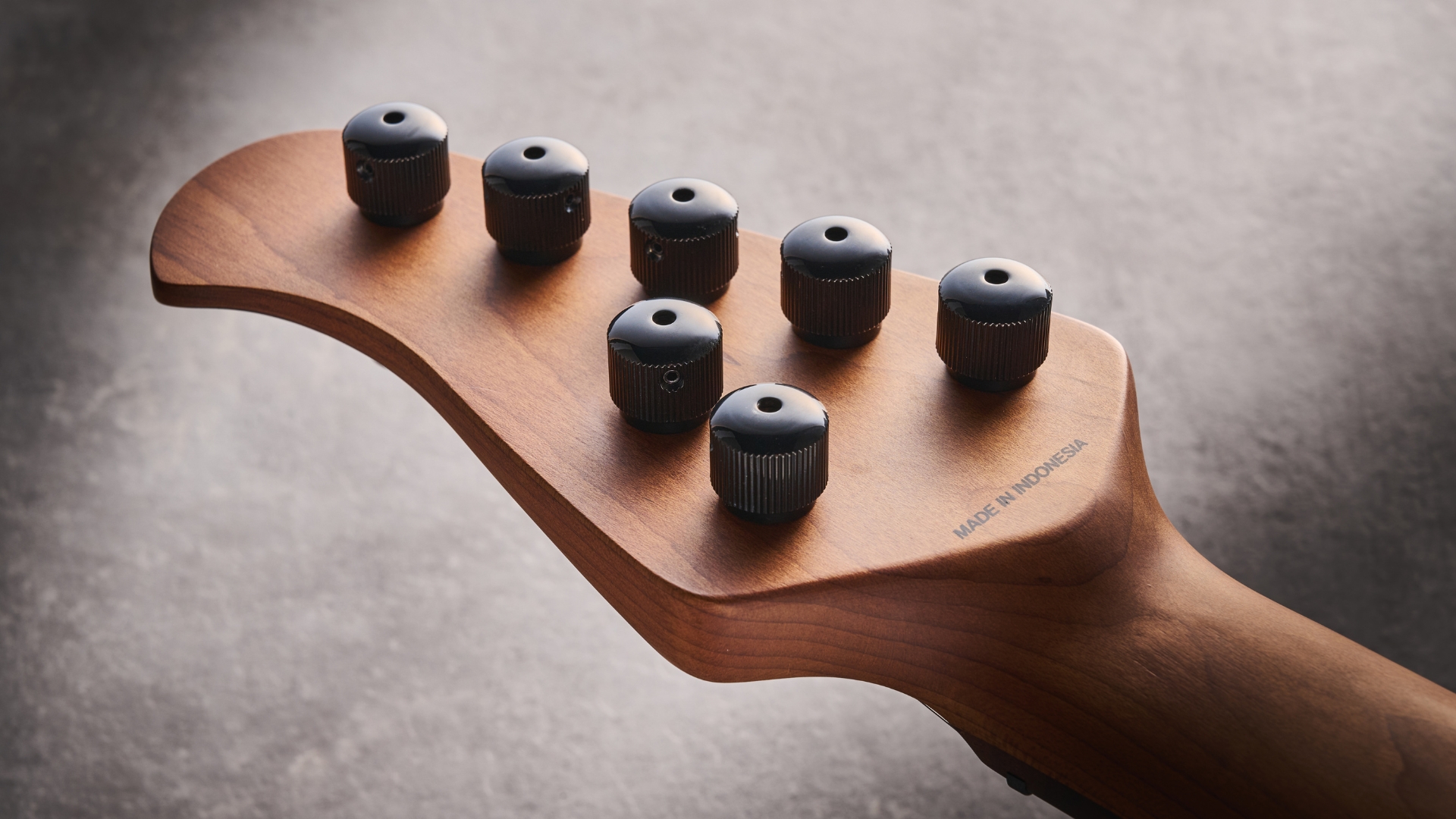 Closeup of the back of the headstock of a Sterling by Music Man Kaizen 7-string electric guitar