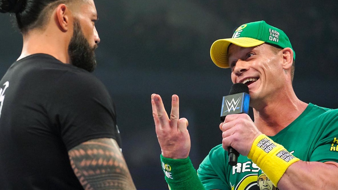 John Cena talks to Roman Reigns
