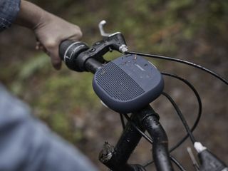 Bose's SoundLink Micro Bluetooth Speaker attached to the handlebars of a mountain bike