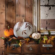 pumpkin decorating ideas pumpkins decorated with decoupage leaf prints on a wooden sideboard