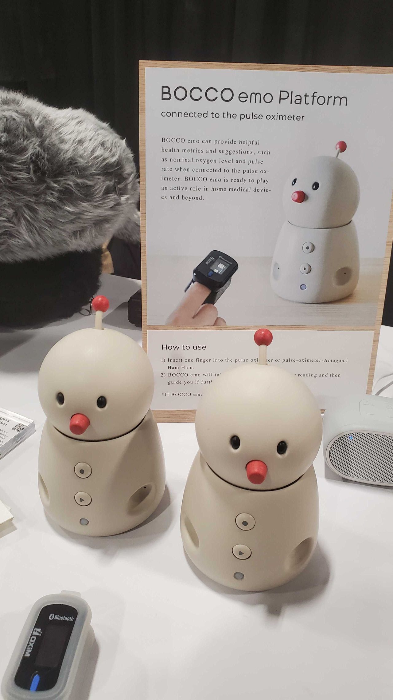 two white robots sitting on table