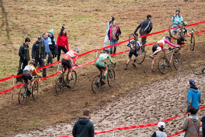 Riders take the side of the course where grassier conditions provide more traction