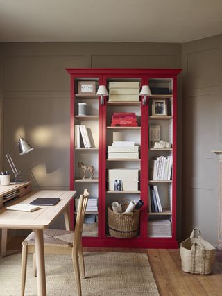 Red bookshelf in a home office