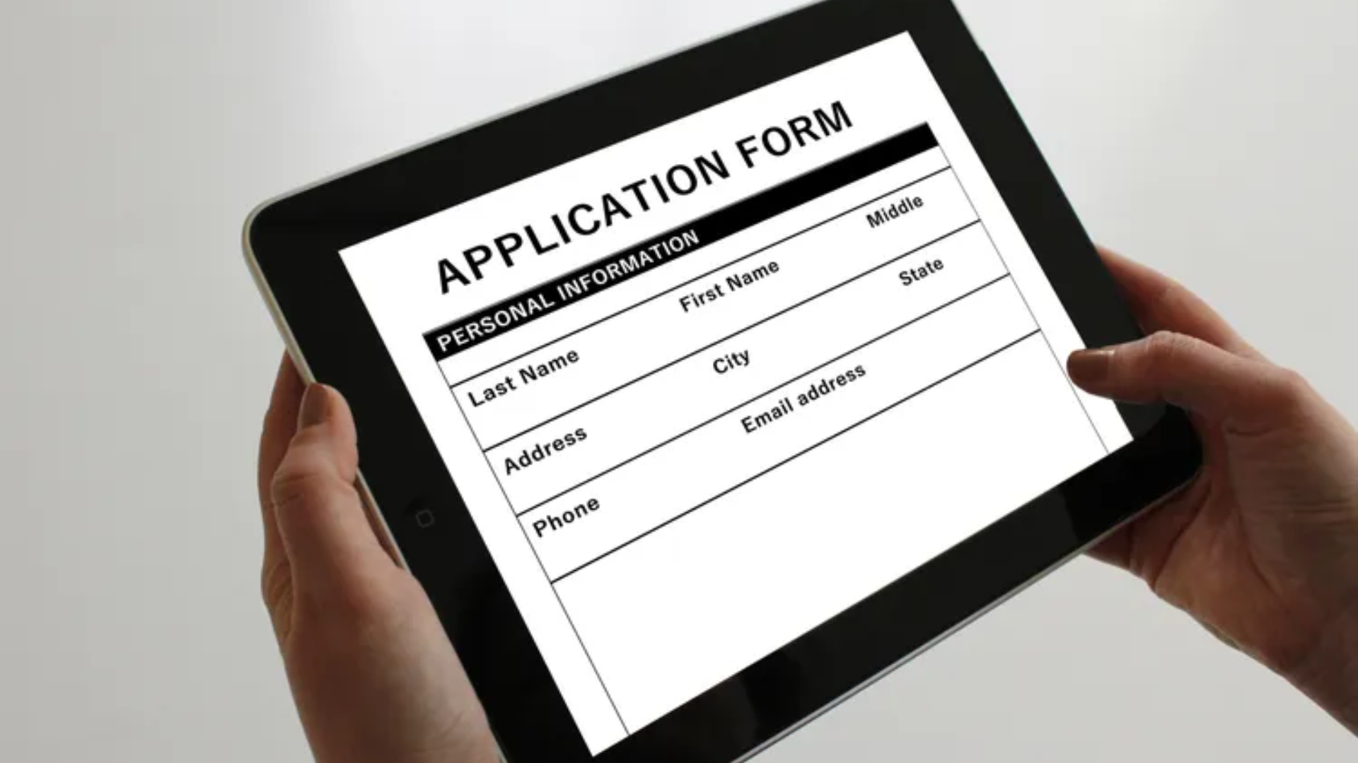 A person holding a tablet with a job application on it