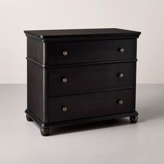 A three-tiered black dresser