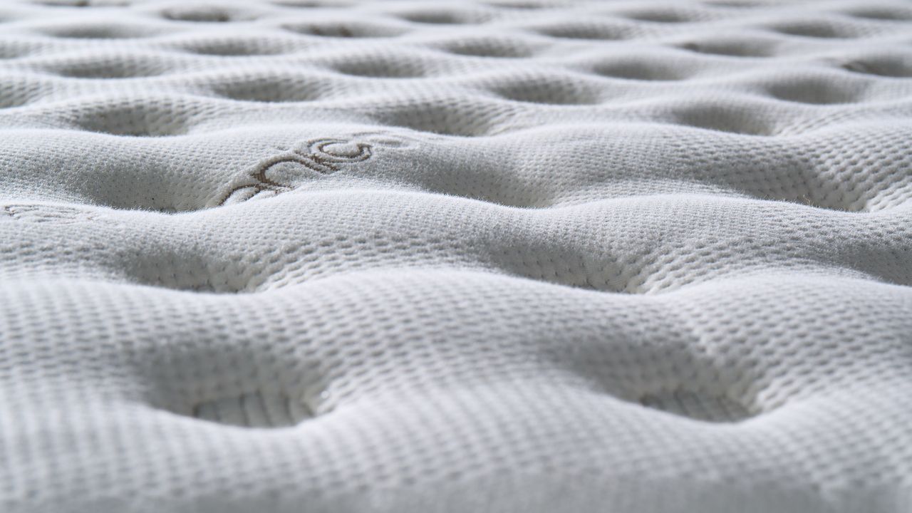 The dimpled cover of the Saatva Classic mattress photographed during testing