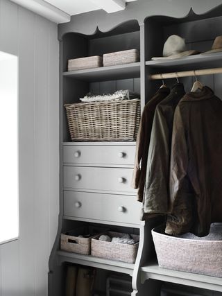 open plan entryway closet with shelves, drawers and hanging, painted in mid grey