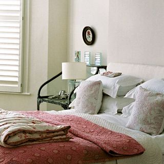 white bedroom with white lamp and white wall