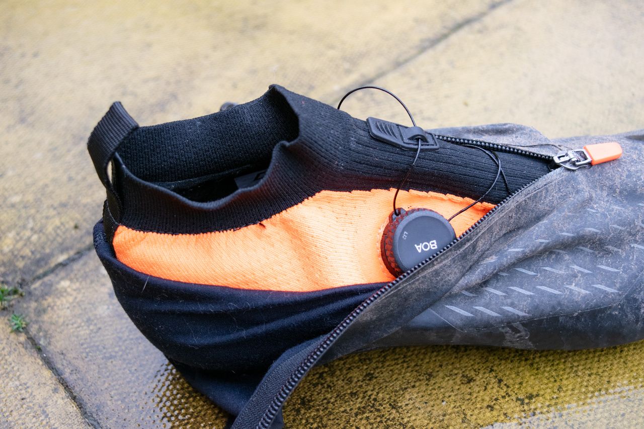 A dirty DMT WKR1 cycling shoe on a patio