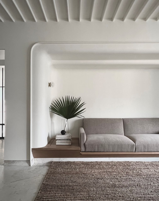 A light grey sofa and cream walls