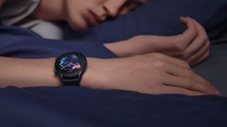 Person sleeping in blue sheets wearing the Amazfit GTR 3 smartwatch