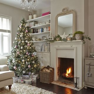 white living room with fire place and christmas tree