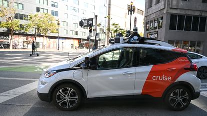 A self-driving car operated by the company Cruise is stopped at a red light.