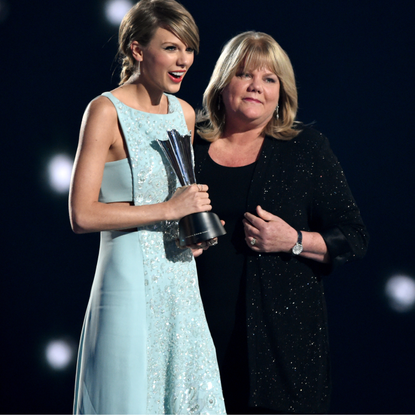 Honoree Taylor Swift (L) accepts the Milestone Award from Andrea Swift onstage during the 50th Academy Of Country Music Awards at AT&T Stadium on April 19, 2015 in Arlington, Texas