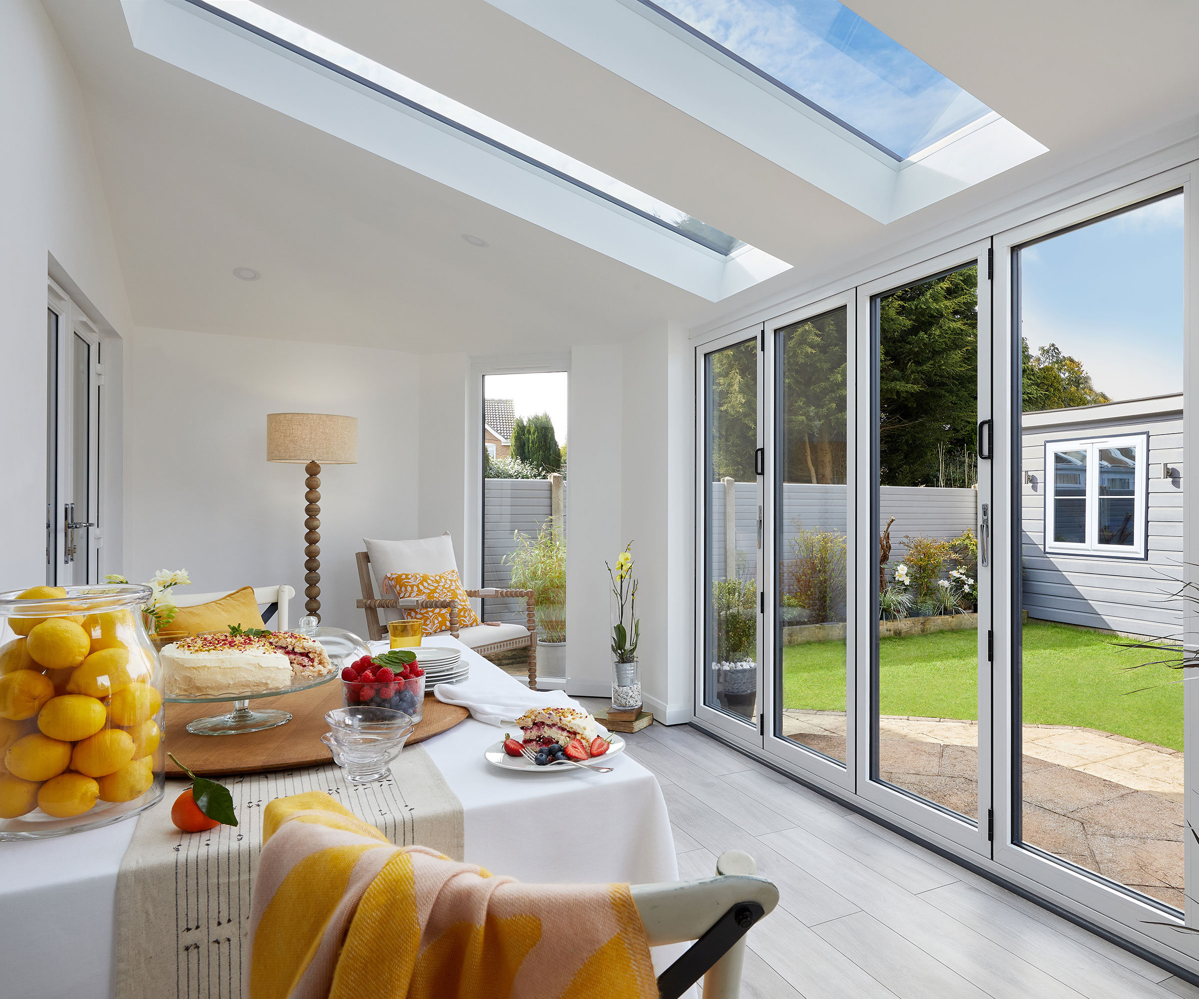 interior shot of prefab extension dining room with pale engineered wood flooring