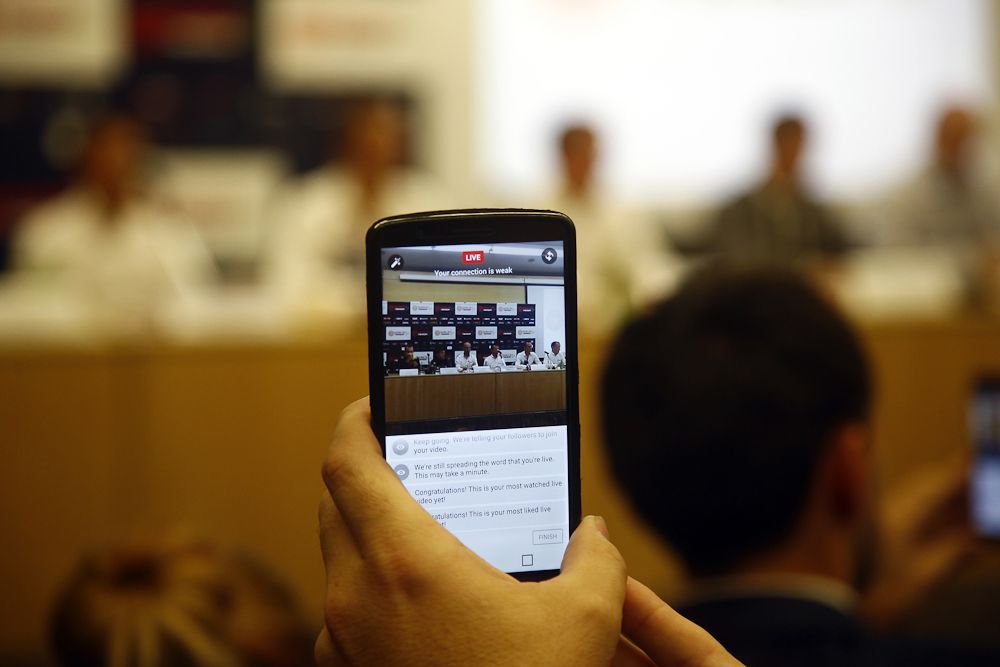 A phone captures the action at the Bahrain Merida press conference