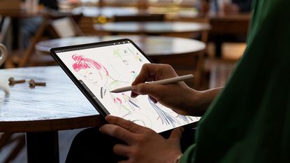 Apple iPad Pro being used by a woman to draw a picture of a woman