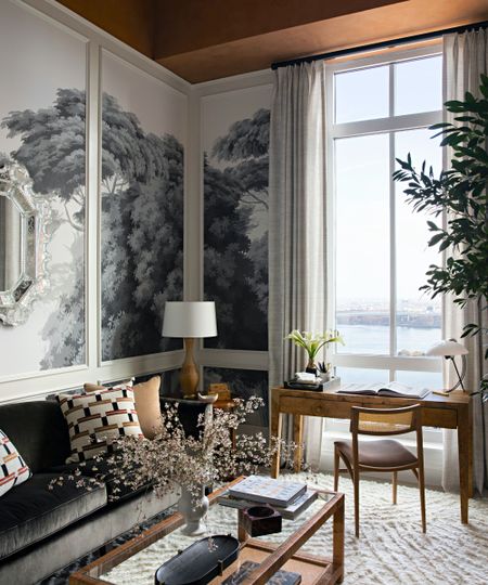 A living room with a monochrome wall mural, plaster ceiling, modern furniture, and a foor-to-ceiling window.