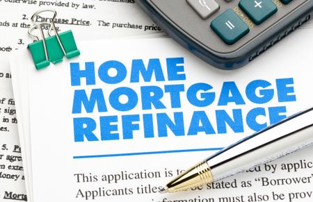 Home Mortgage Refinance Application and pen and calculator