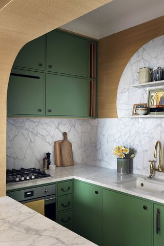 Small green galley kitchen in a London apartment