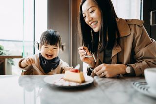 Woman with child in restaurant as rule of six comes back for England in the summer