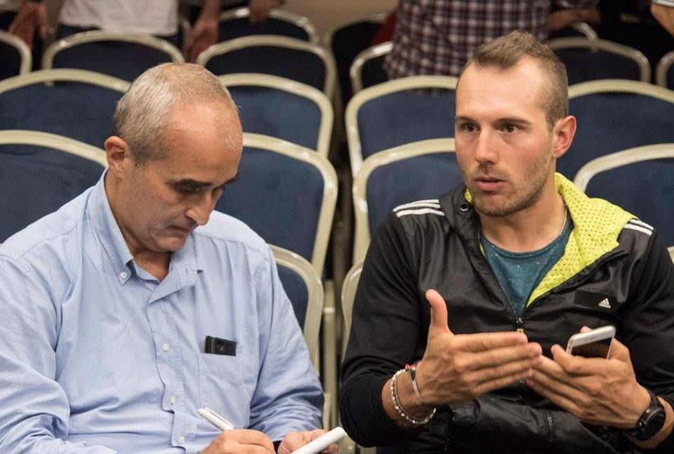 Sonny Colbrelli speaks with a journalist during the Bahrain Merida media day