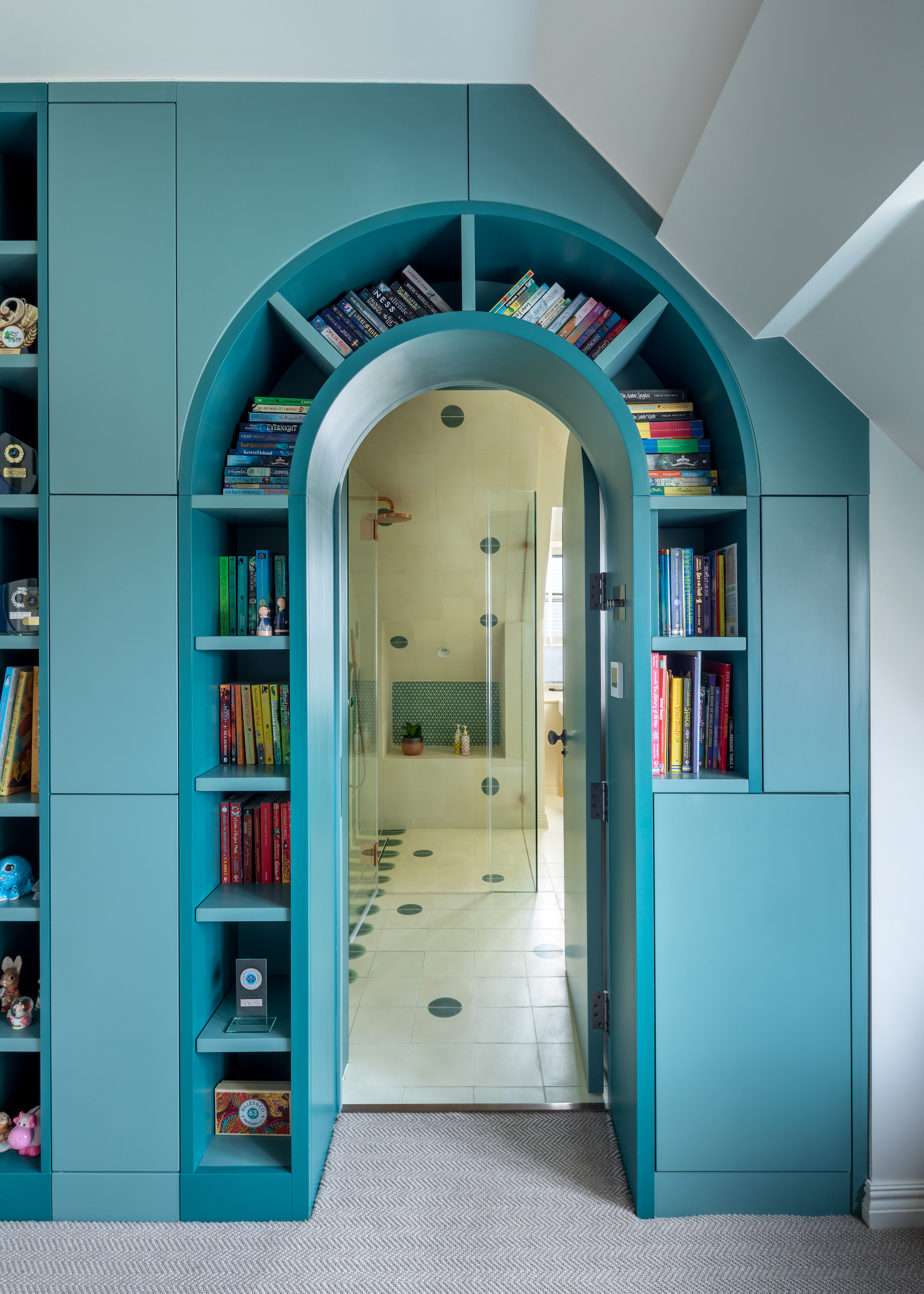 loft with bookshelves curved around the entrance