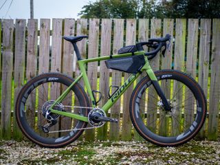 Detail photo of a green Ridley ASTR RS leaning against a wooden fence