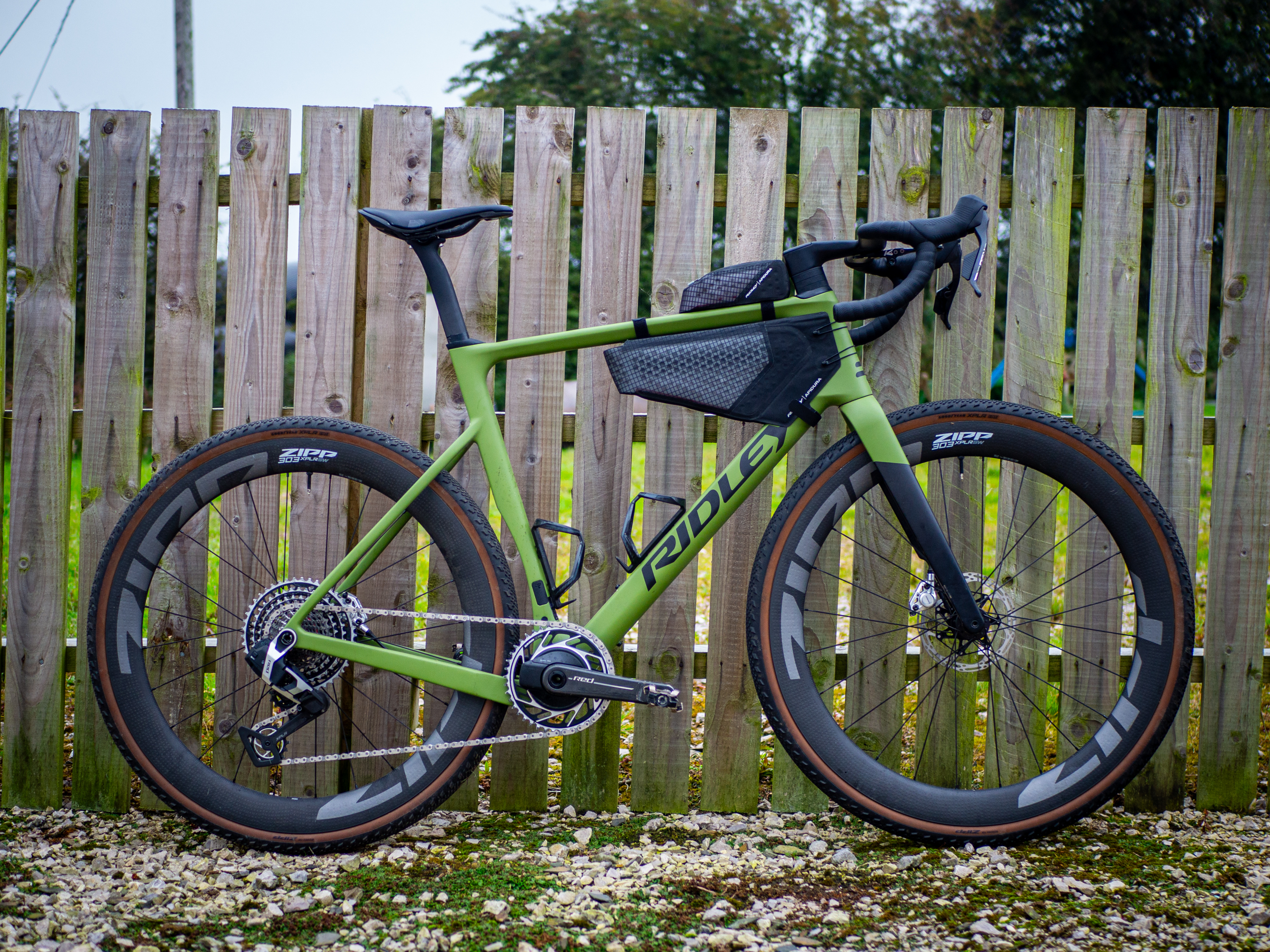 Detail photo of a green Ridley ASTR RS leaning against a wooden fence